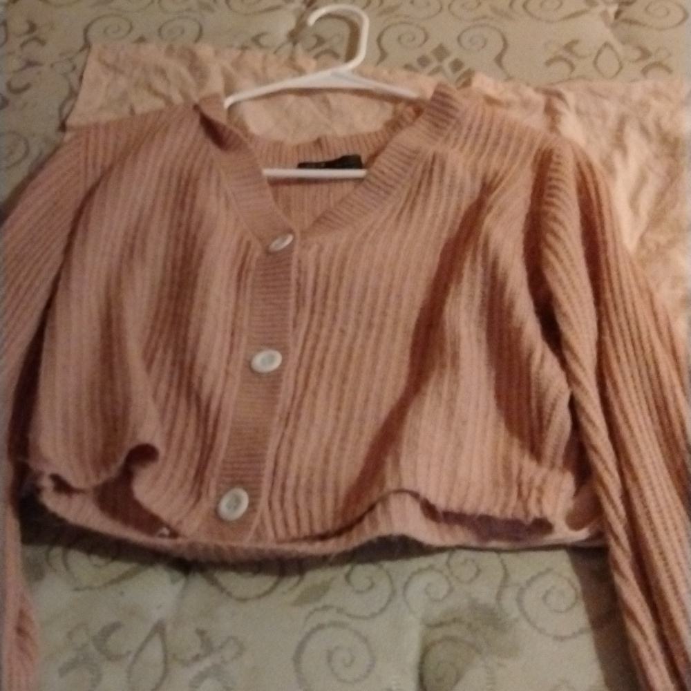 Used she in light pink cardigan